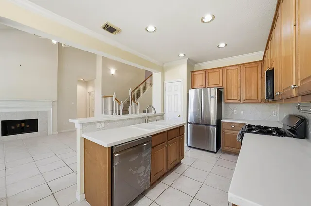 a kitchen with a sink a stove and refrigerator