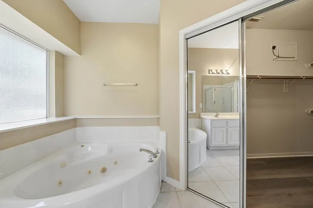 a bathroom with a bathtub and a shower