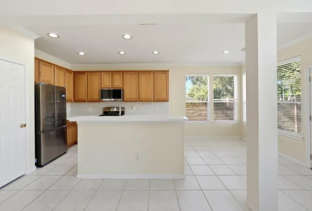 a kitchen with stainless steel appliances granite countertop a refrigerator and a sink