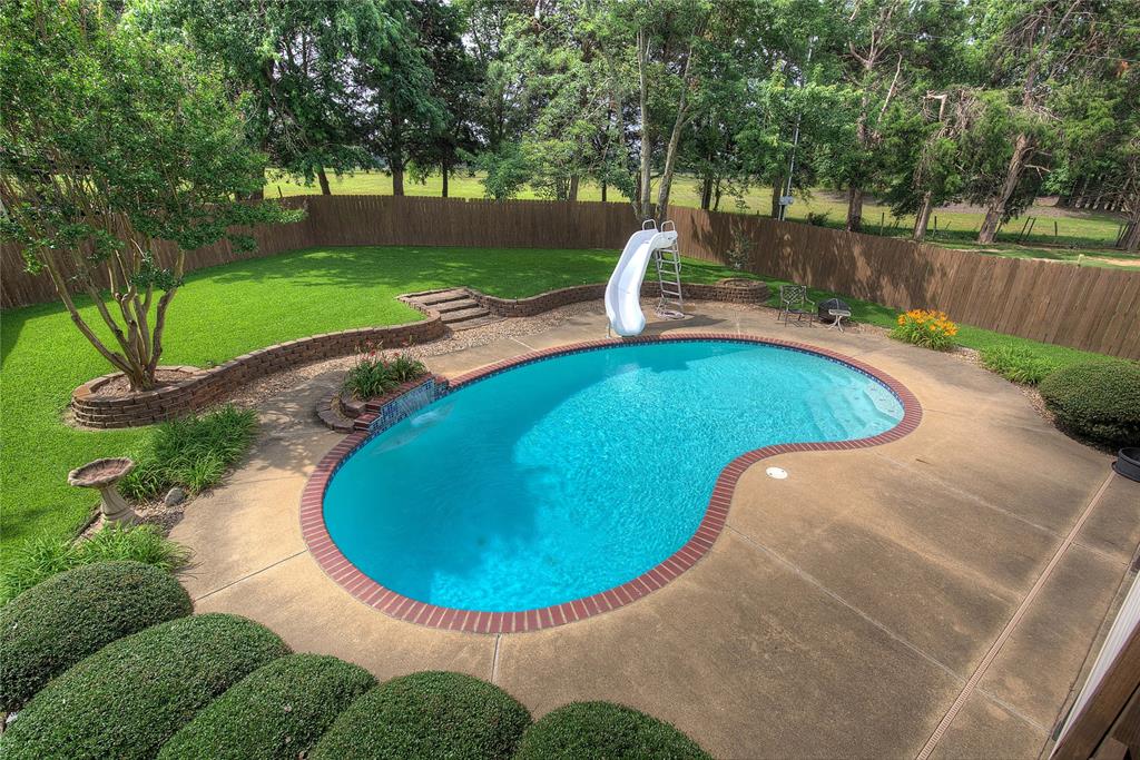 753 County Rd SW 3110 Mount Vernon, TX 75457 - Photo 3 of 40 Gorgeous in-ground pool with waterfall and slide, plus manicured St. Augustine lawn and privacy fence