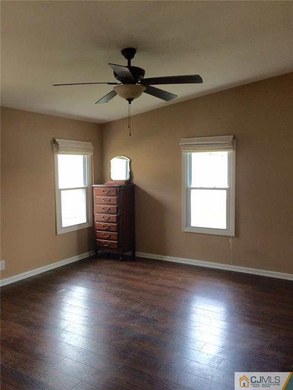 39 Poe Road, Unit 39 North Brunswick, NJ 08902 - Photo 11 of 21 a view of an empty room with wooden floor and a window