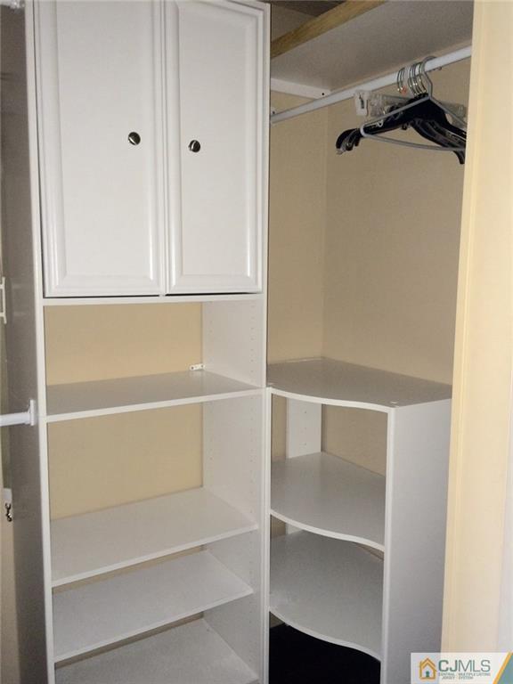 39 Poe Road, Unit 39 North Brunswick, NJ 08902 - Photo 14 of 21 a view of walk in closet with empty racks