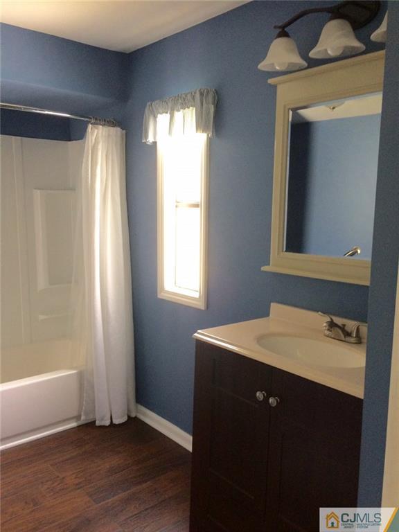 39 Poe Road, Unit 39 North Brunswick, NJ 08902 - Photo 16 of 21 a bathroom with a sink a mirror and a bathtub