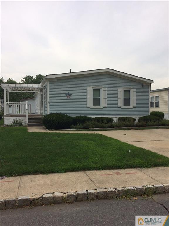 39 Poe Road, Unit 39 North Brunswick, NJ 08902 - Photo 3 of 21 a front view of a house with a garden and yard