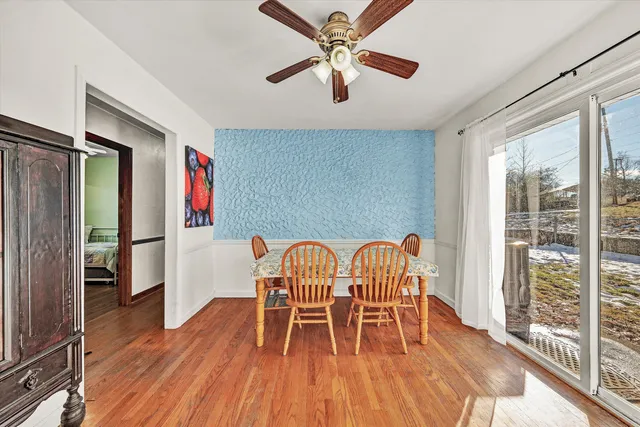 a view of a dining room with furniture window and wooden floor