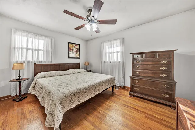 a bedroom with a bed a chandelier and a window