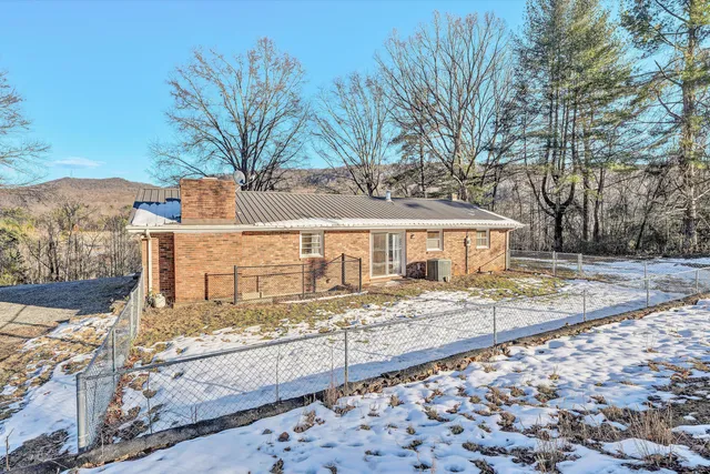 a view of a house with snow on the background