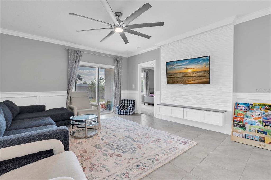 31130 Penny Surf Loop Wesley Chapel, FL 33545 - Photo 11 of 42 a living room with furniture and a flat screen tv
