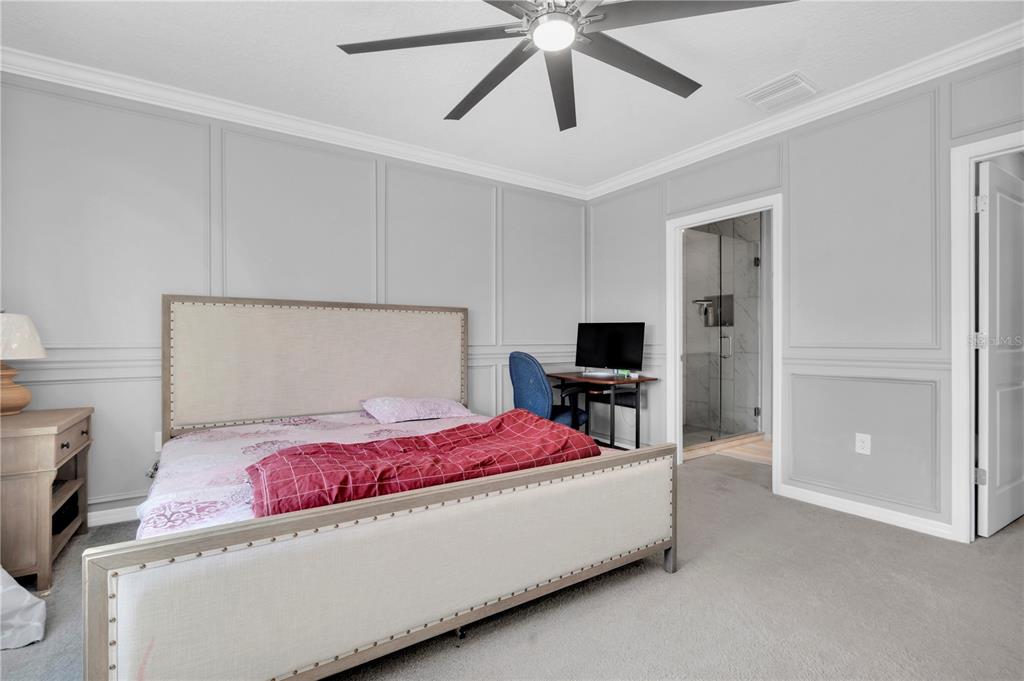 31130 Penny Surf Loop Wesley Chapel, FL 33545 - Photo 15 of 42 a bedroom with a bed and a ceiling fan