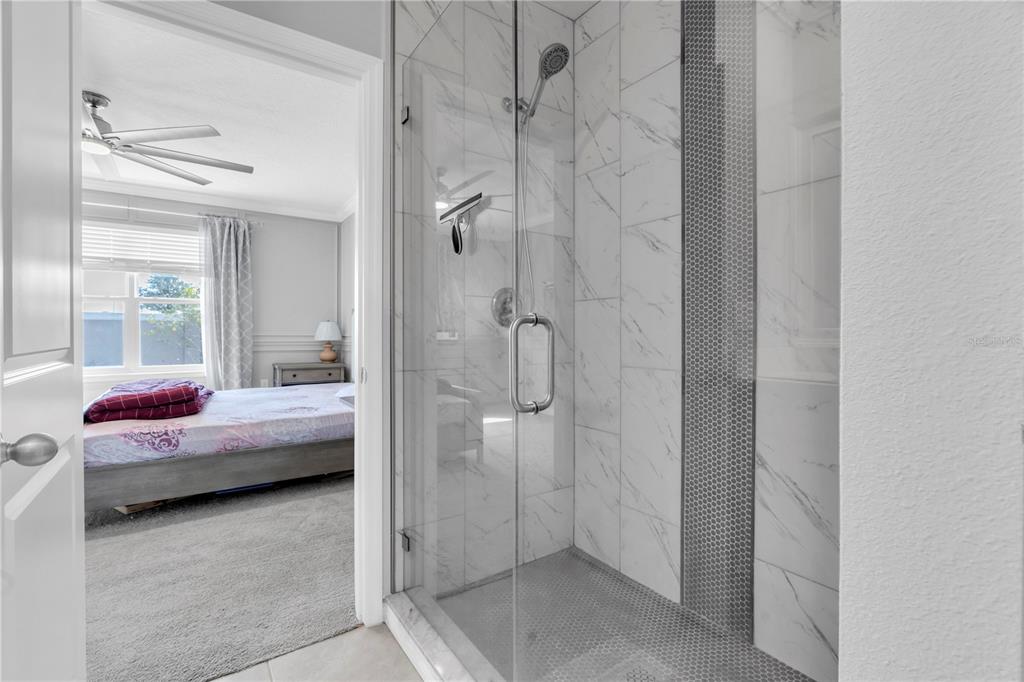 31130 Penny Surf Loop Wesley Chapel, FL 33545 - Photo 18 of 42 a en suite bathroom with a granite countertop tub and a shower