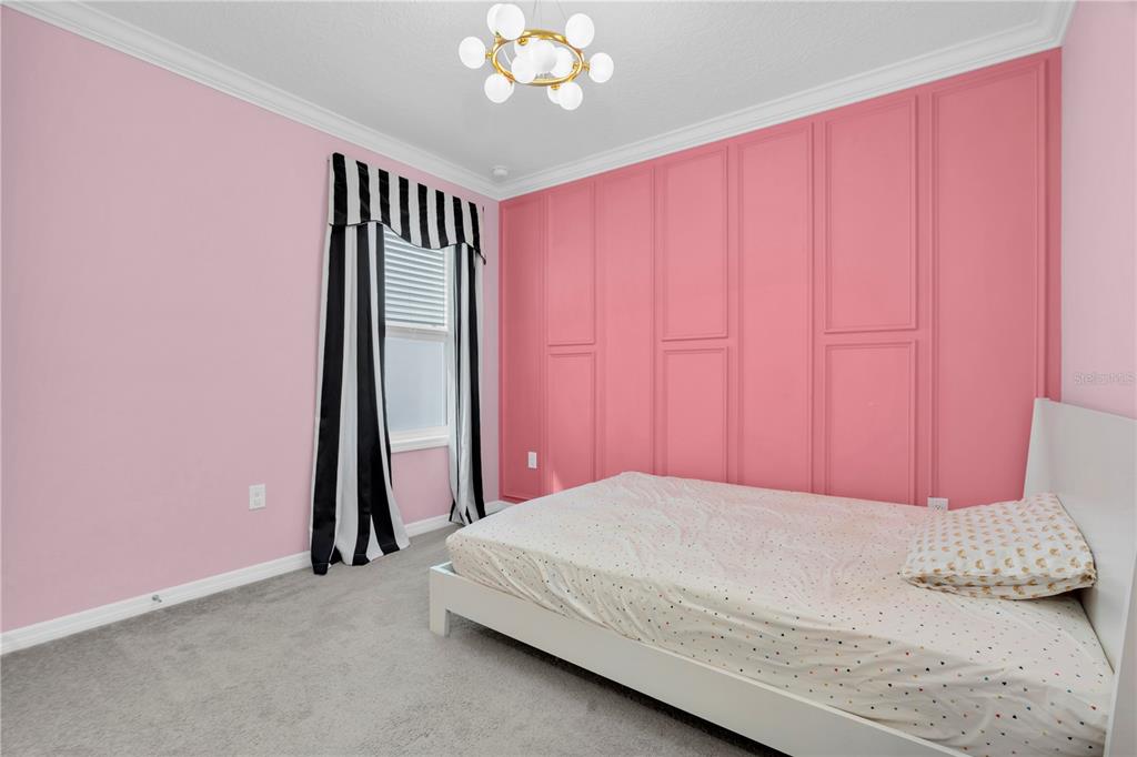 31130 Penny Surf Loop Wesley Chapel, FL 33545 - Photo 22 of 42 a bedroom with a bed and a chandelier