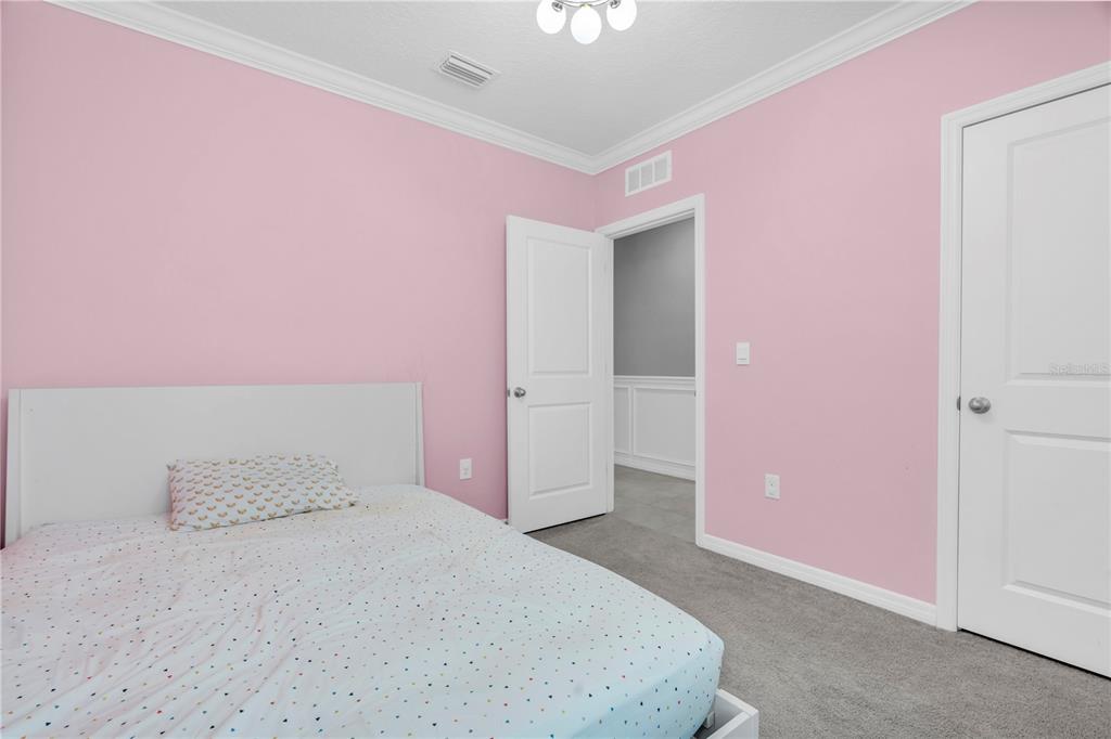 31130 Penny Surf Loop Wesley Chapel, FL 33545 - Photo 23 of 42 a bedroom with pink walls