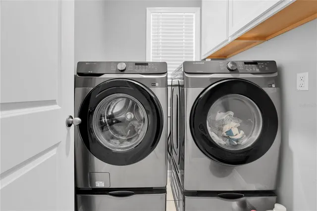 a view of a backyard with plants and outdoor seating