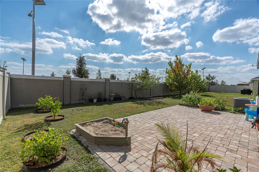 31130 Penny Surf Loop Wesley Chapel, FL 33545 - Photo 25 of 42 a view of a backyard with plants and outdoor seating