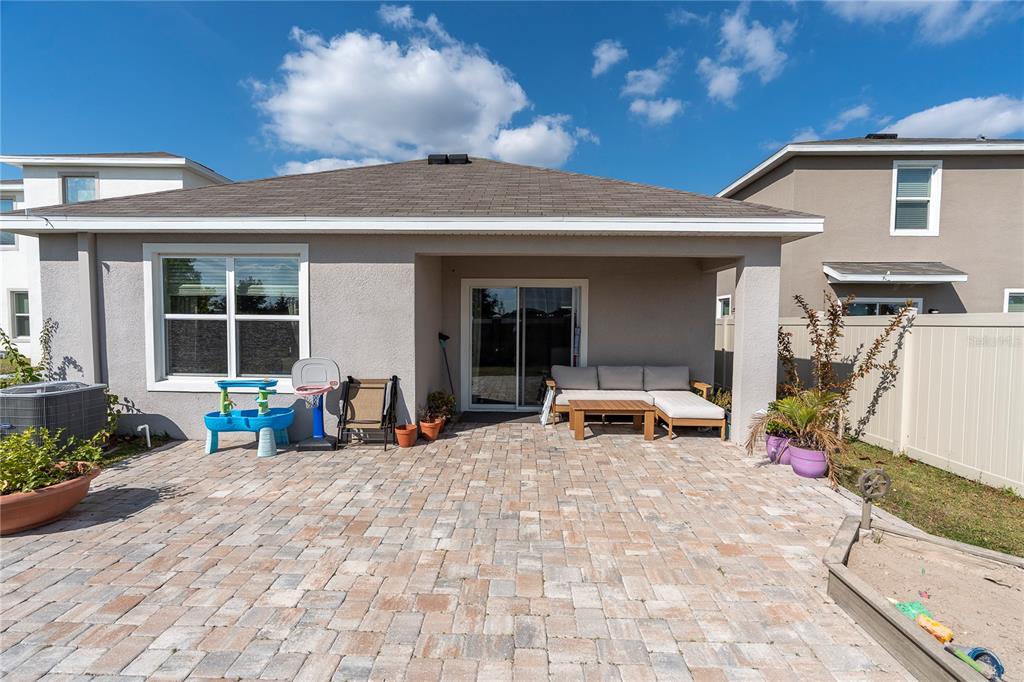 31130 Penny Surf Loop Wesley Chapel, FL 33545 - Photo 28 of 42 a view of a house with lounge chair and a barbeque