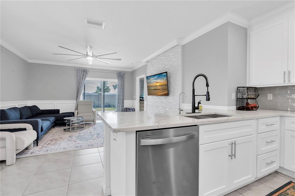 31130 Penny Surf Loop Wesley Chapel, FL 33545 - Photo 8 of 42 a kitchen with stainless steel appliances granite countertop a sink and white cabinets
