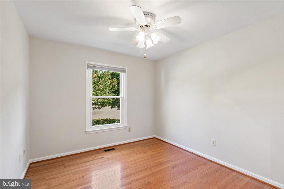 8307 Southstream Run Springfield, VA 22153 - Photo 12 of 49 wooden floor in an empty room with a window