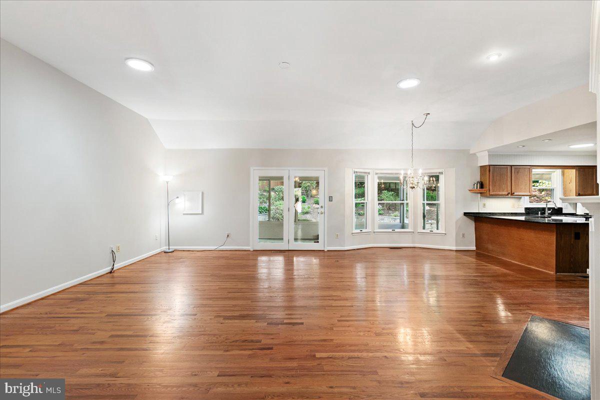 8307 Southstream Run Springfield, VA 22153 - Photo 17 of 49 a view of an empty room with wooden floor and a window
