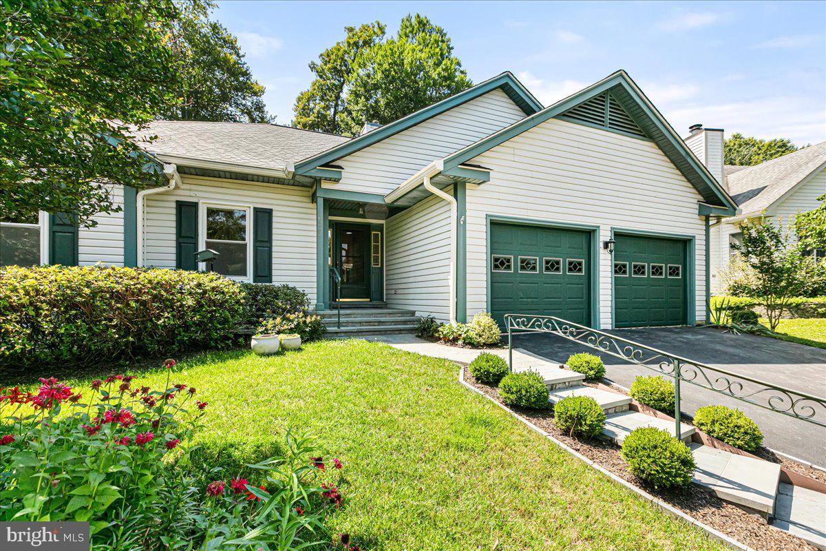 8307 Southstream Run Springfield, VA 22153 - Photo 2 of 49 a front view of a house with a porch and a yard