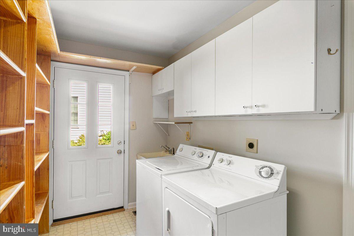8307 Southstream Run Springfield, VA 22153 - Photo 28 of 49 a utility room with cabinets washer and dryer