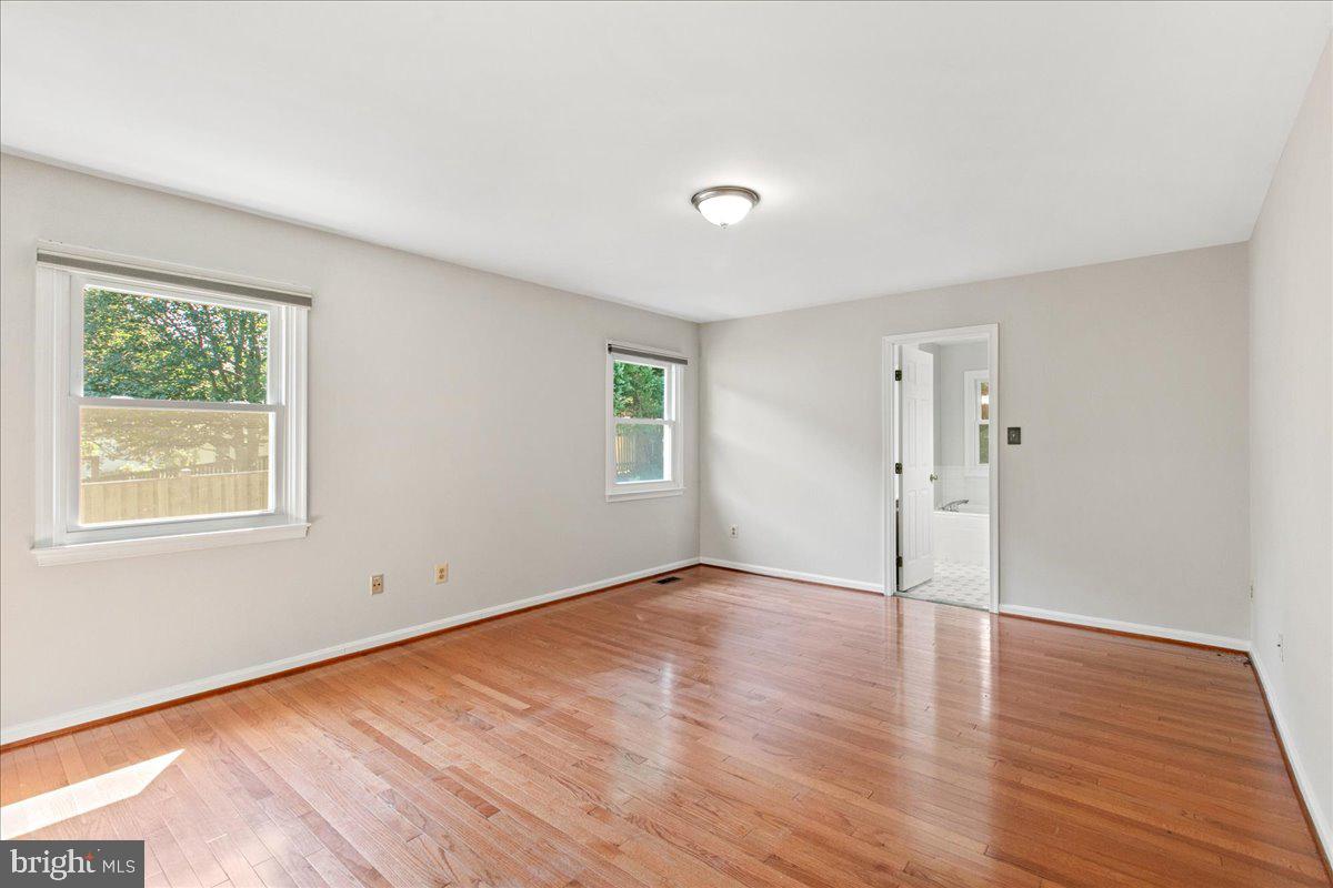 8307 Southstream Run Springfield, VA 22153 - Photo 3 of 49 an empty room with wooden floor and windows