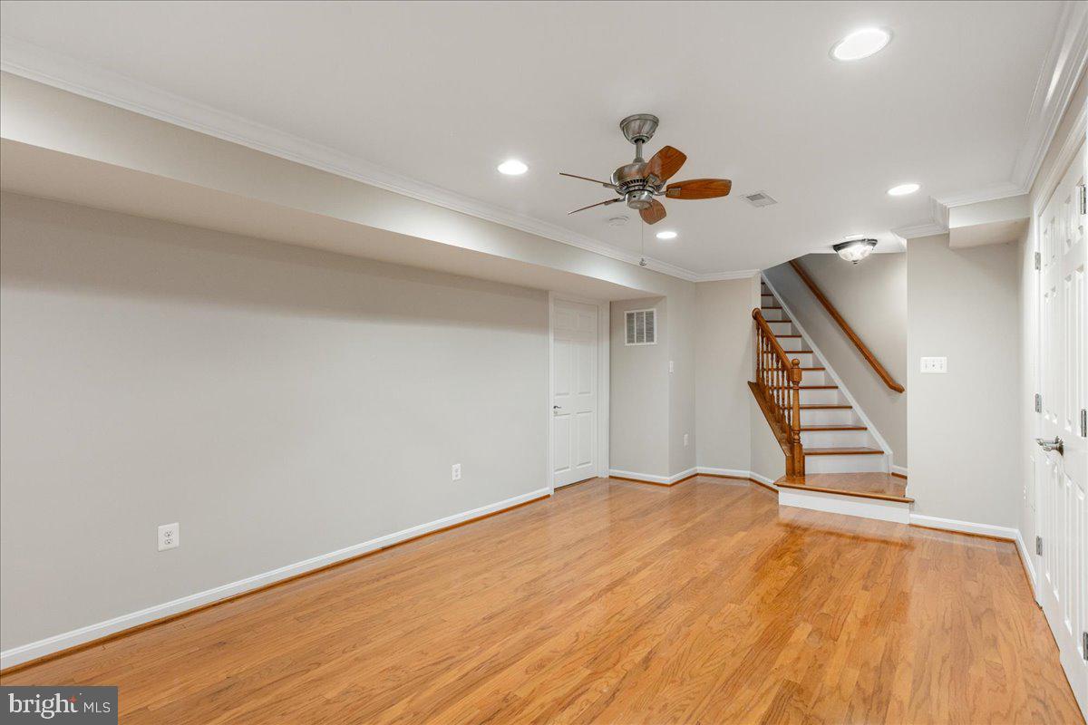 8307 Southstream Run Springfield, VA 22153 - Photo 31 of 49 wooden floor in an empty room with stairs