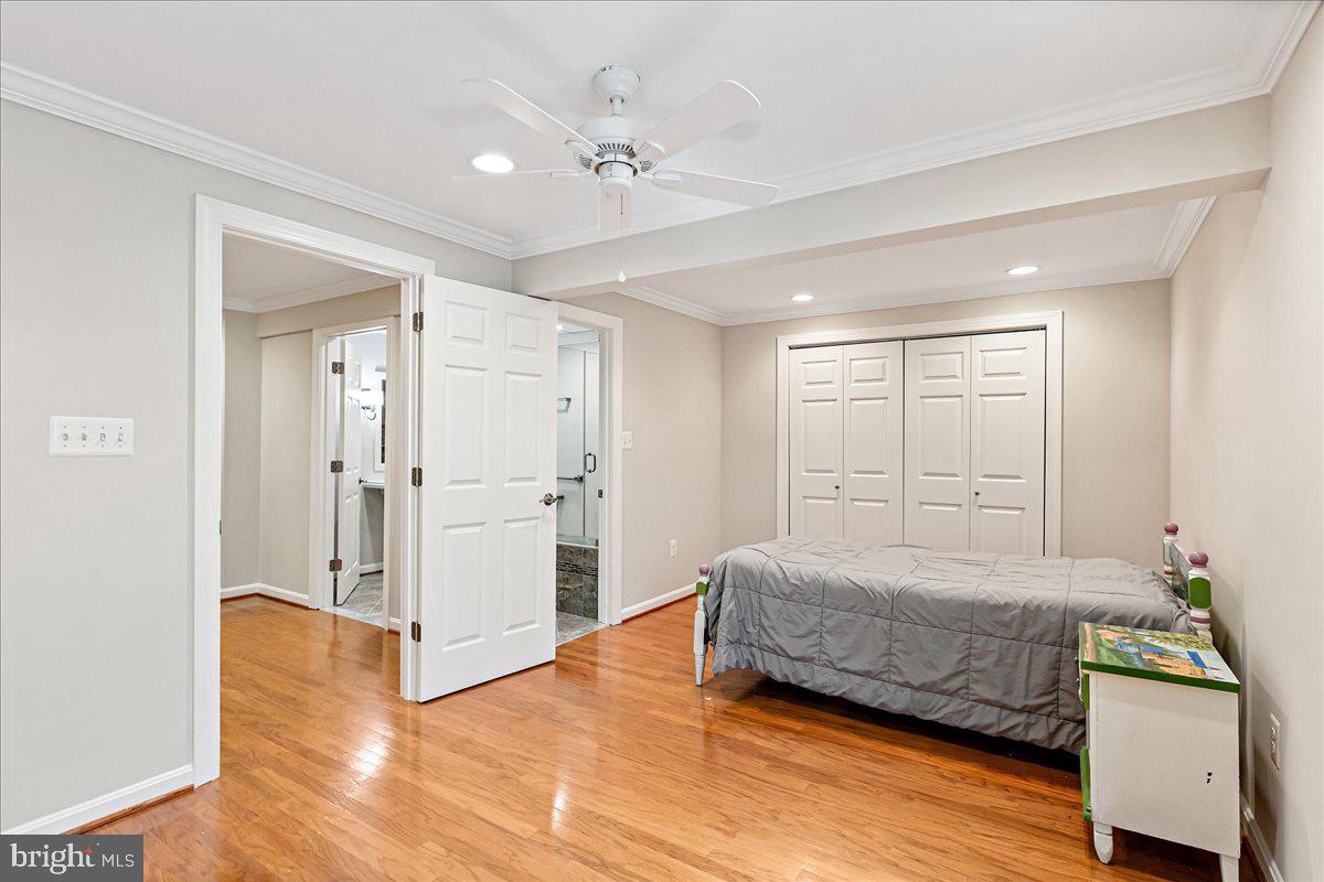 8307 Southstream Run Springfield, VA 22153 - Photo 33 of 49 a bedroom with a bed and a chandelier