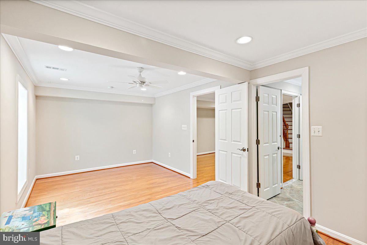 8307 Southstream Run Springfield, VA 22153 - Photo 34 of 49 a bedroom with a bed and wooden floor