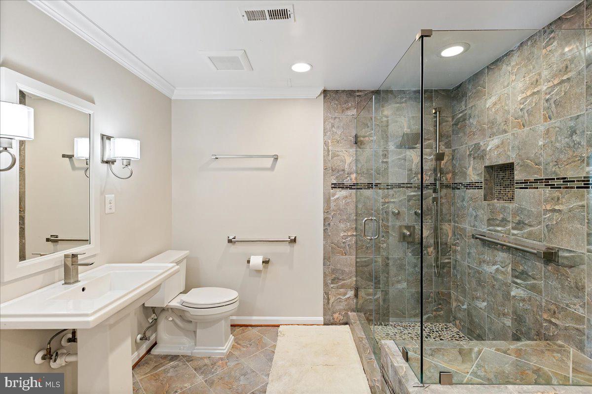 8307 Southstream Run Springfield, VA 22153 - Photo 35 of 49 a bathroom with a toilet a sink and shower