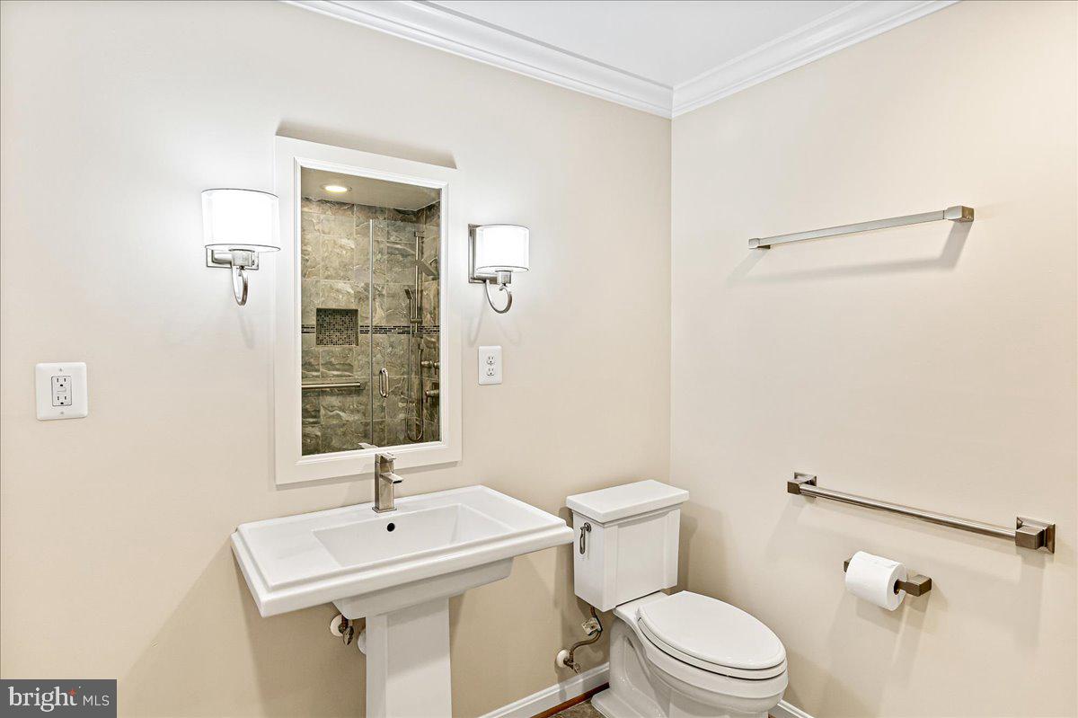 8307 Southstream Run Springfield, VA 22153 - Photo 36 of 49 a bathroom with a sink a toilet and shower