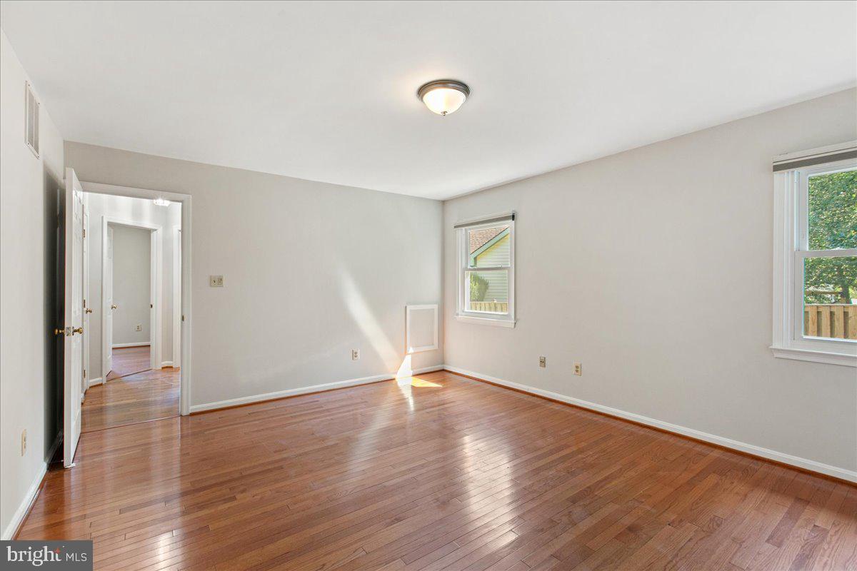 8307 Southstream Run Springfield, VA 22153 - Photo 4 of 49 an empty room with wooden floor and windows