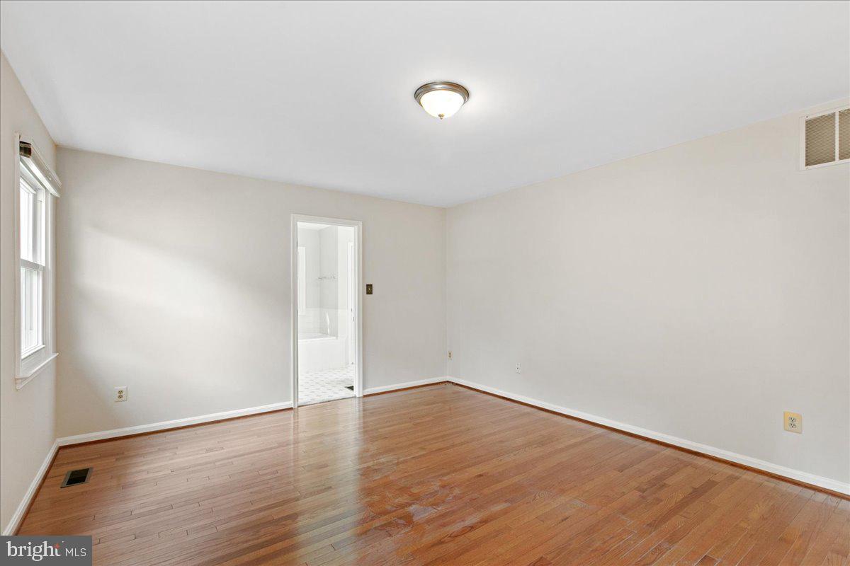 8307 Southstream Run Springfield, VA 22153 - Photo 5 of 49 a view of an empty room with wooden floor