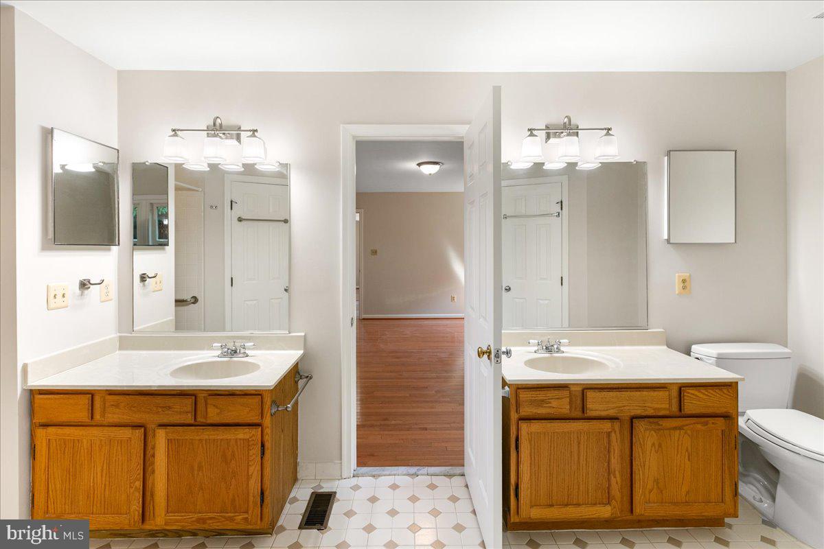 8307 Southstream Run Springfield, VA 22153 - Photo 9 of 49 a bathroom with a sink double vanity and a mirror