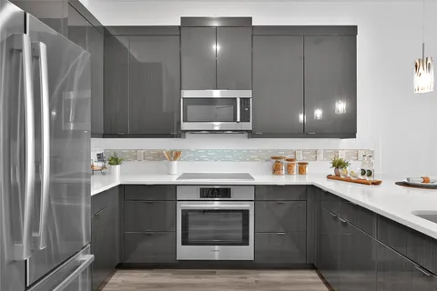 a kitchen with a sink cabinets and stainless steel appliances