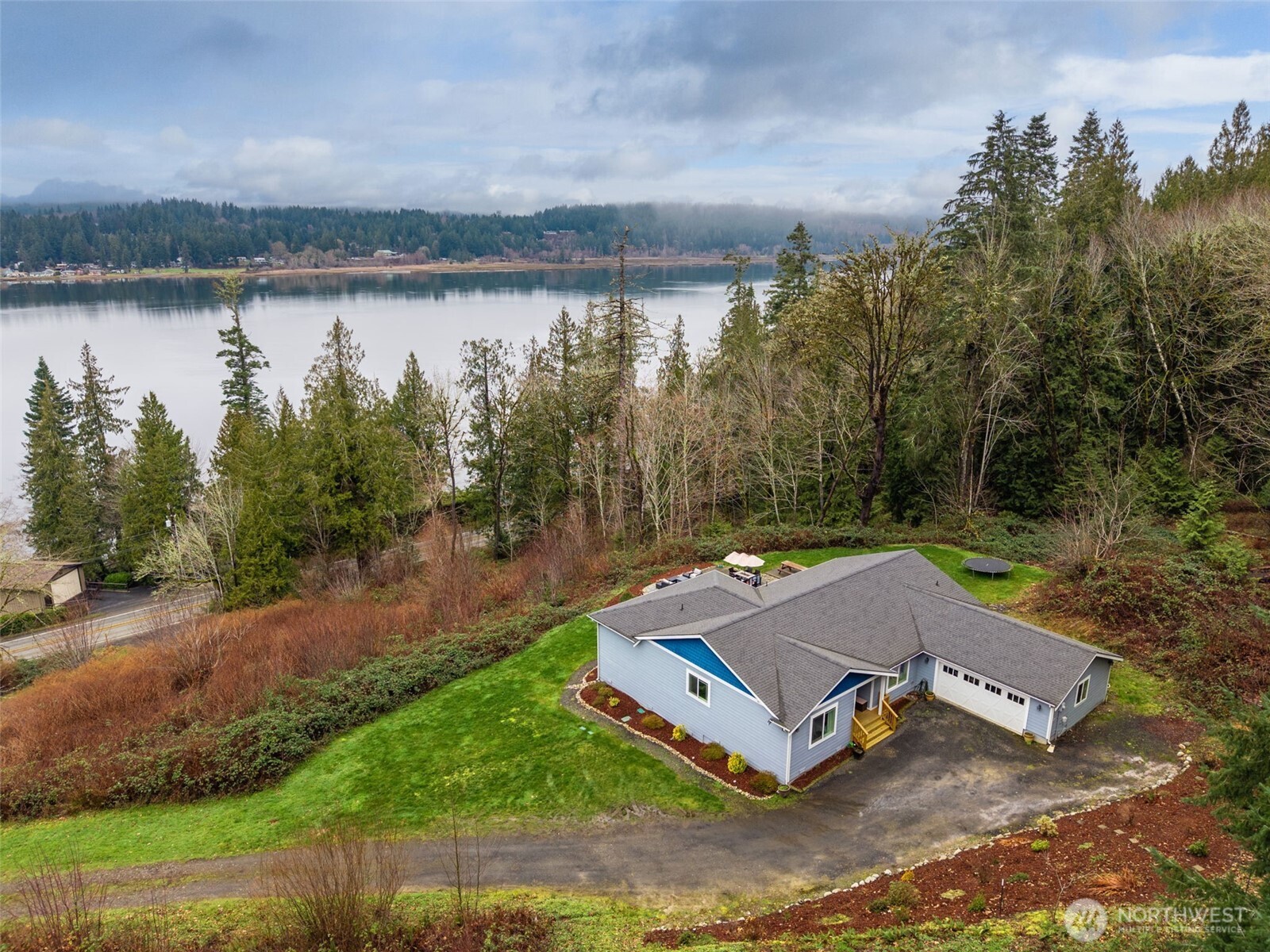 31 East Cove View Drive Belfair, WA 98528 - Photo 3 of 23 an aerial view of a house with a yard and lake view