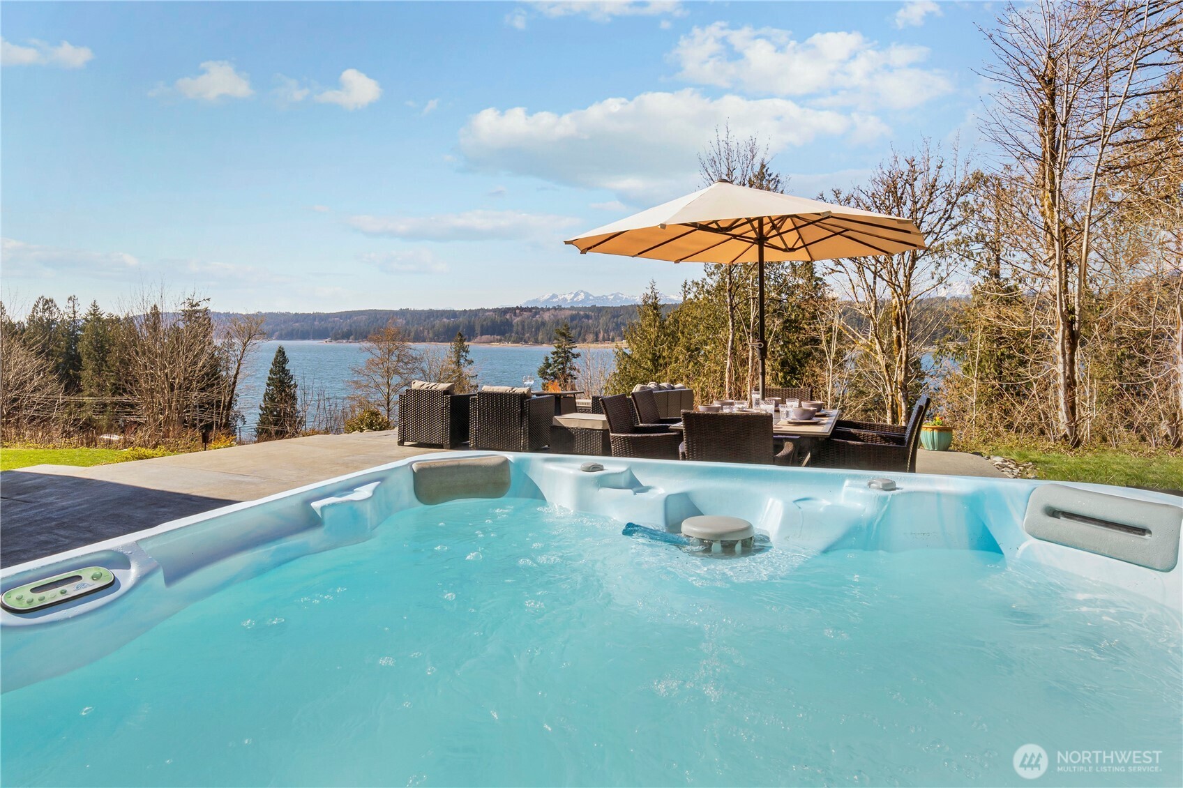 31 East Cove View Drive Belfair, WA 98528 - Photo 4 of 23 a view of swimming pool with a table and chairs under an umbrella