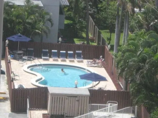 a view of backyard with swimming pool and outdoor seating