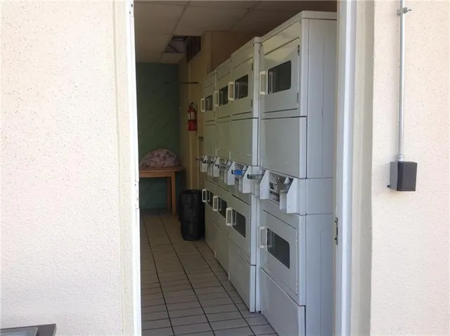 a kitchen with stainless steel appliances granite countertop a refrigerator and a stove