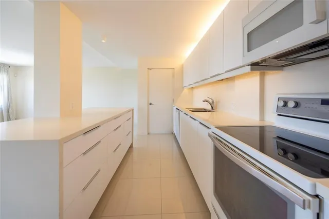 a kitchen with a sink and a refrigerator