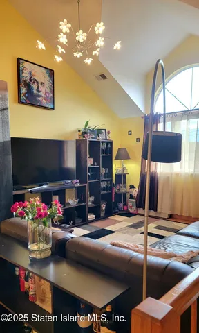 a bed room with furniture and a flat screen tv