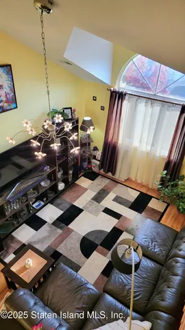 a bedroom with a bed next to a window