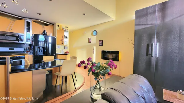 a reading room with furniture and view of kitchen