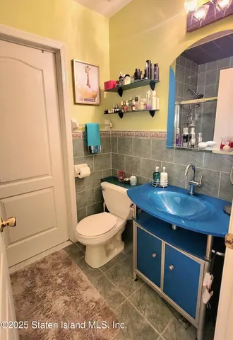 a white toilet sitting next to a bathroom sink