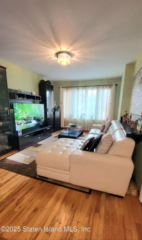 a room with table chairs and a refrigerator