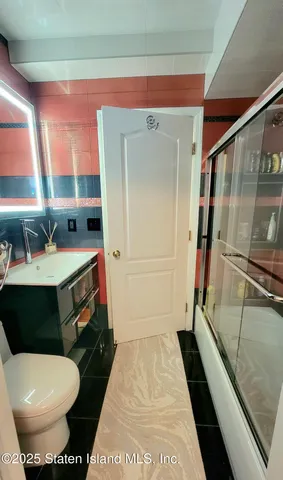 a bedroom with a bed and a night stand