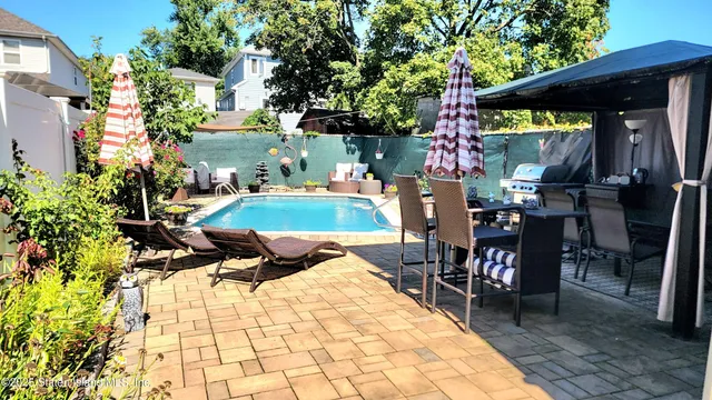 a view of a swimming pool with sitting area