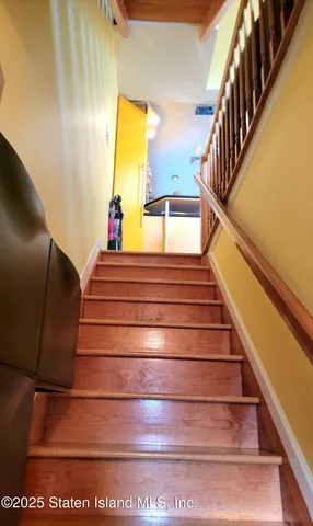 a kitchen with stainless steel appliances kitchen island granite countertop a sink and a view of living room