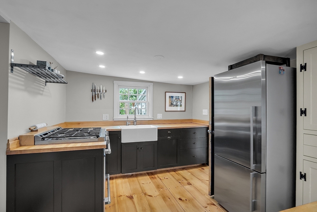 16 River Street Salem, MA 01970 - Photo 11 of 37 a kitchen with kitchen island stainless steel appliances a sink stove and refrigerator