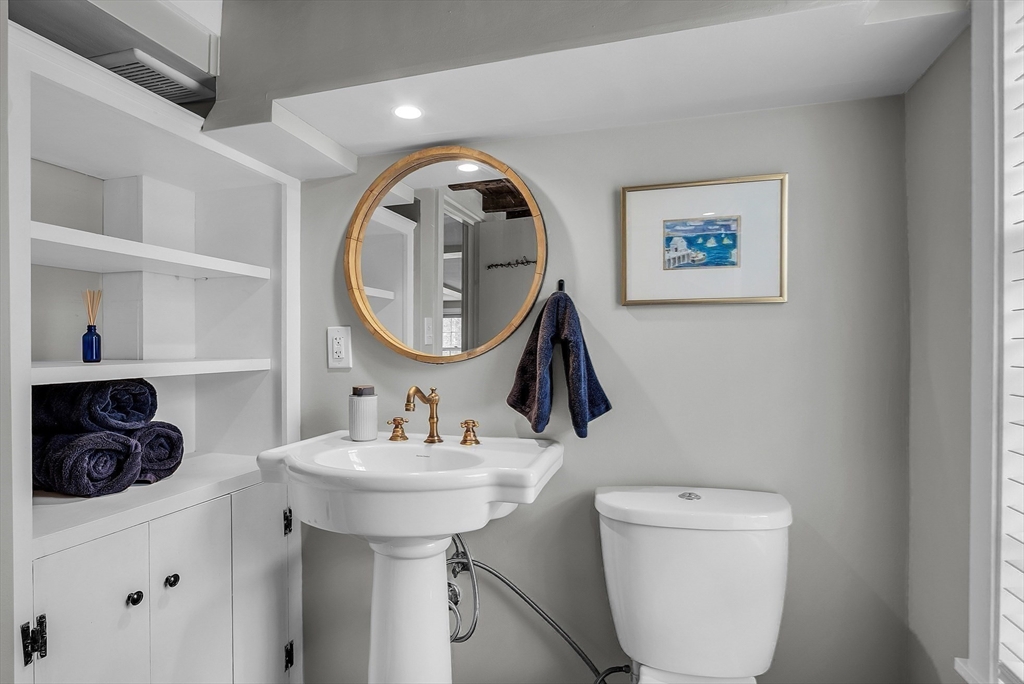 16 River Street Salem, MA 01970 - Photo 17 of 37 a bathroom with a toilet a sink and a mirror