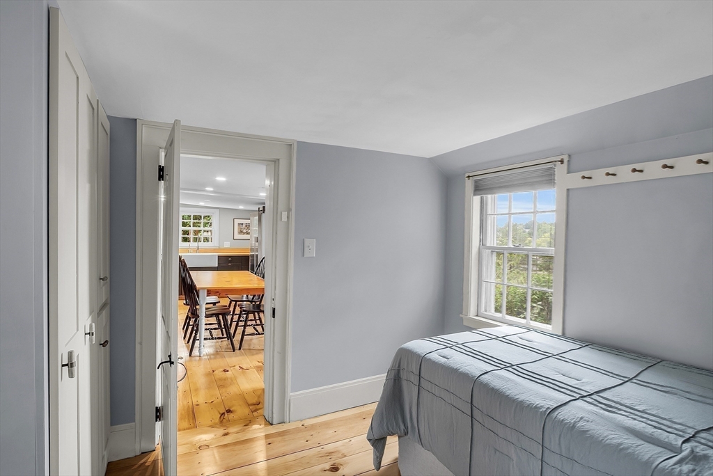 16 River Street Salem, MA 01970 - Photo 20 of 37 a bedroom with a bed and a dresser next to a window